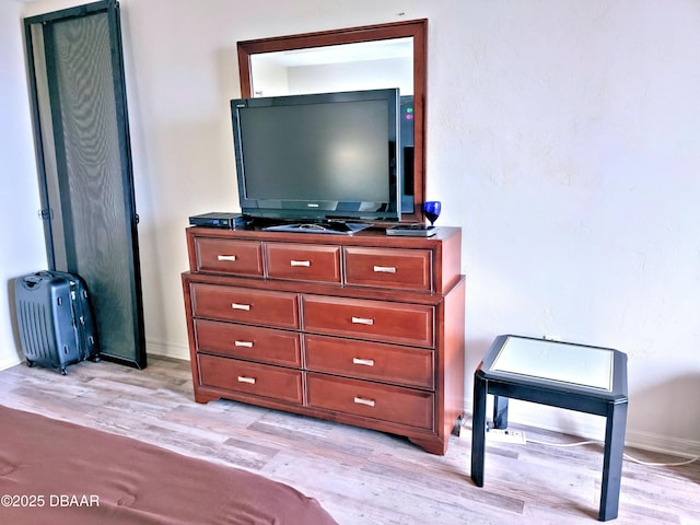 bedroom featuring light wood-type flooring and baseboards