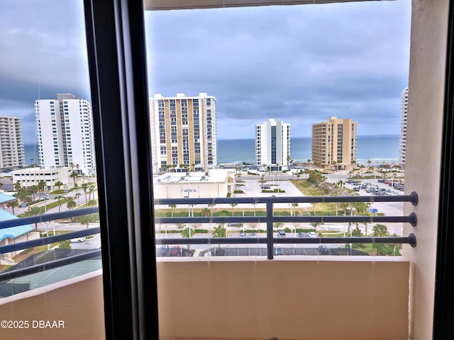 balcony with a view of city and a water view