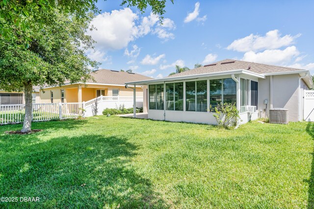 1748 Savannah Ln, Port Orange, FL 32128 - rear view of property featuring a sunroom, stucco siding, and central air condition unit