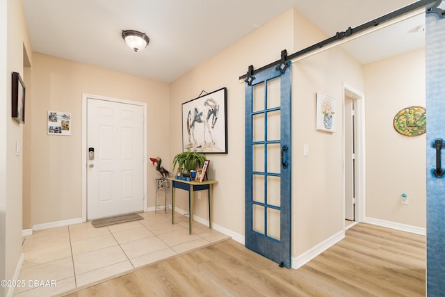 1748 Savannah Ln, Port Orange, FL 32128 - entrance foyer featuring a barn door, wood finished floors, and baseboards