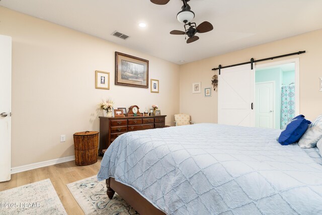 1748 Savannah Ln, Port Orange, FL 32128 - bedroom featuring a barn door, light wood-style floors, baseboards, recessed lighting, and ceiling fan
