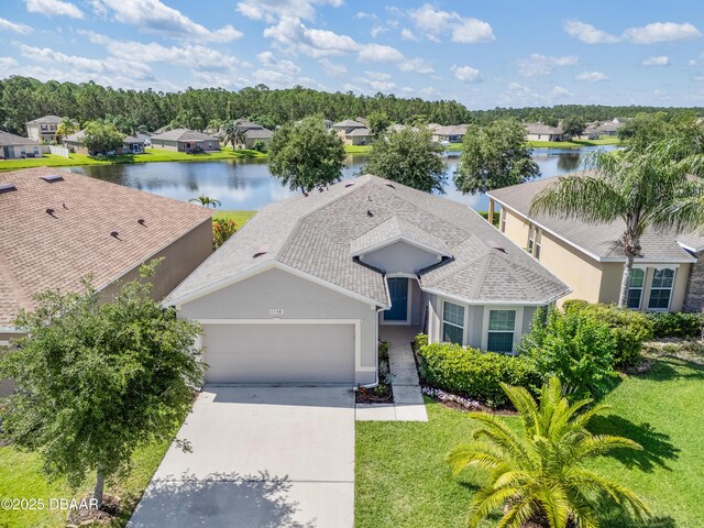1748 Savannah Ln, Port Orange, FL 32128 - view of front of house with a garage, a water view, concrete driveway, and a residential view