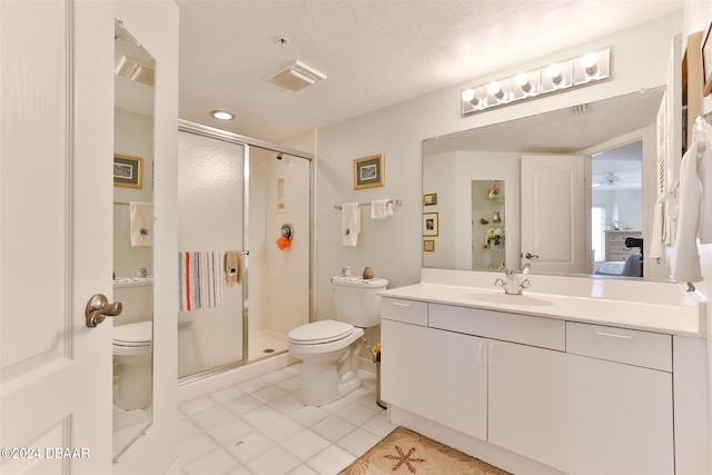 bathroom featuring walk in shower, tile patterned flooring, vanity, and toilet