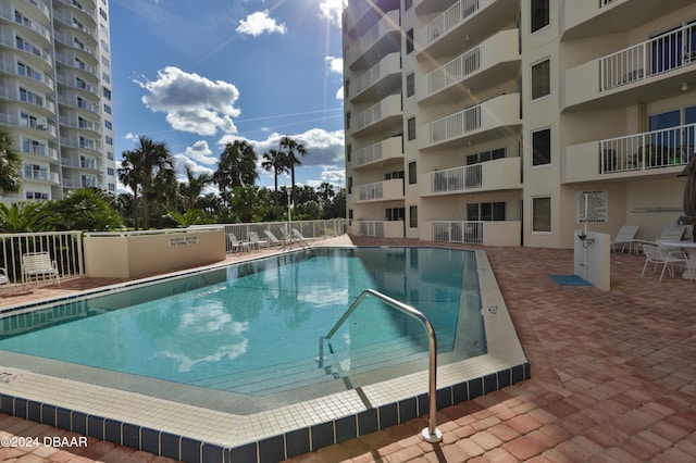 view of swimming pool with a patio