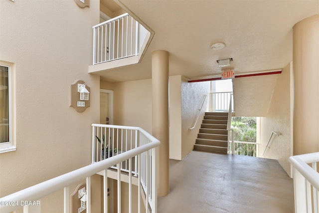 hall with concrete flooring