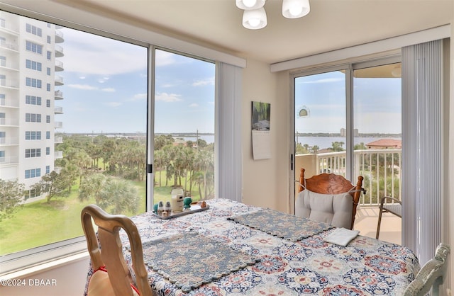 dining space featuring a wealth of natural light and a water view