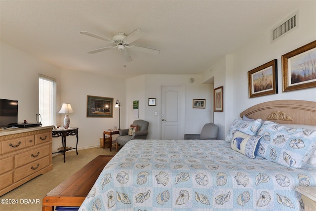 bedroom with ceiling fan and light carpet