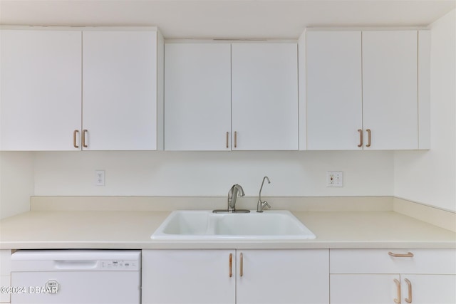 kitchen with white cabinetry, sink, and white dishwasher