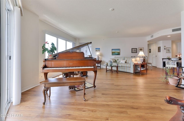 miscellaneous room featuring a textured ceiling and light hardwood / wood-style flooring