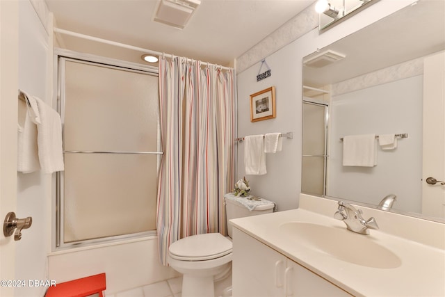 full bathroom featuring toilet, bath / shower combo with glass door, vanity, and tile patterned flooring