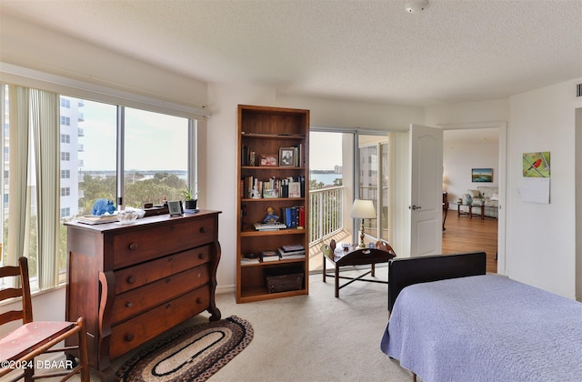 carpeted bedroom featuring a textured ceiling