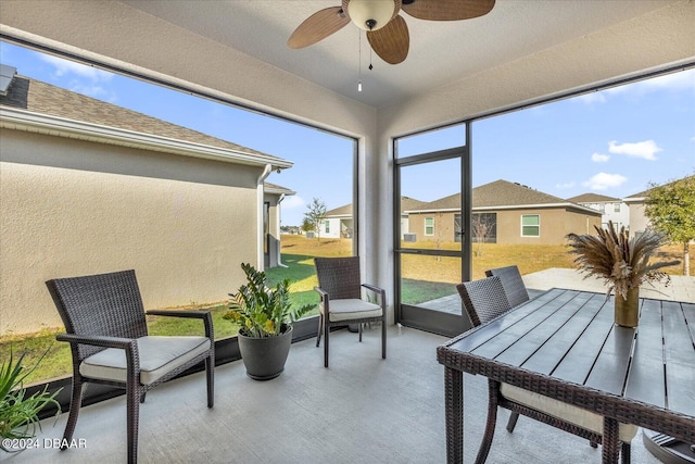 sunroom featuring ceiling fan