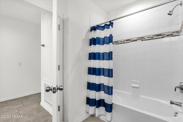 bathroom with tile patterned flooring and shower / bath combination with curtain