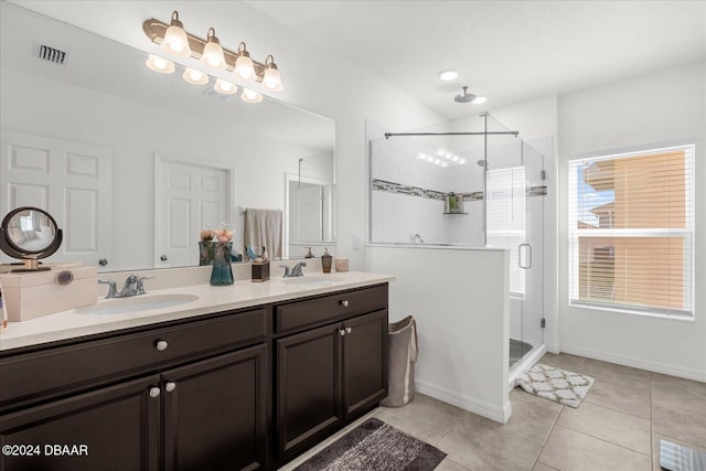 bathroom with tile patterned flooring, vanity, and a shower with shower door