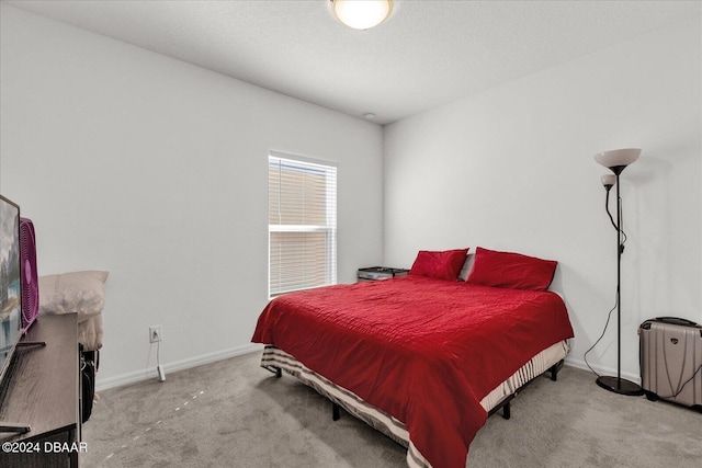 bedroom featuring light carpet