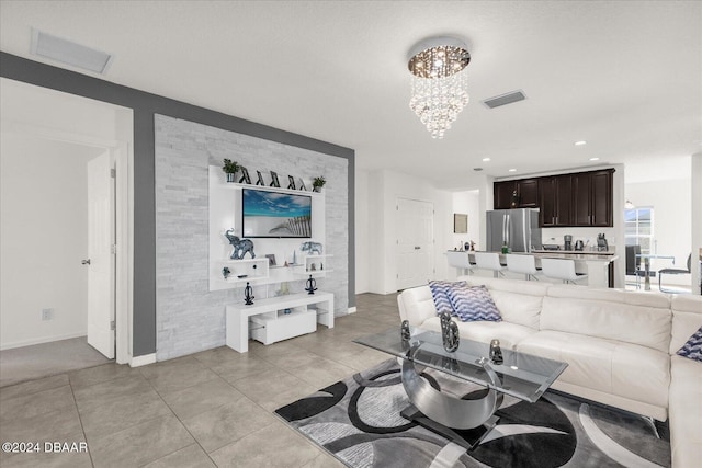 tiled living room featuring a chandelier