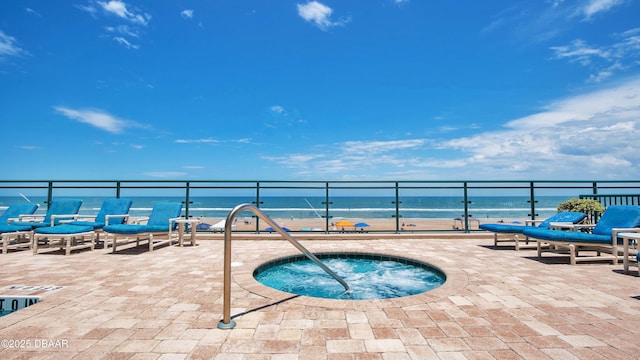 view of pool featuring a community hot tub, a patio, and a water view