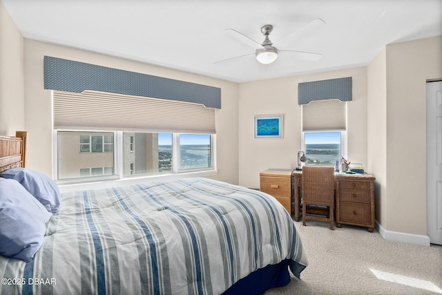 bedroom with ceiling fan and light carpet