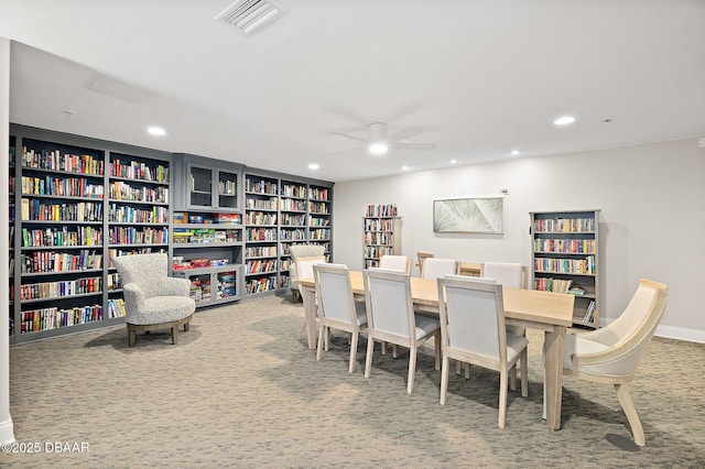 carpeted dining area featuring ceiling fan