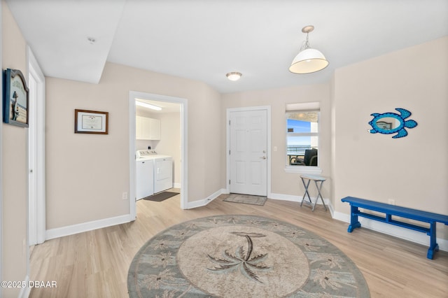 foyer featuring light hardwood / wood-style flooring and washing machine and dryer