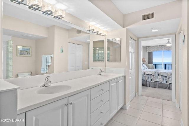 bathroom with vanity, tile patterned floors, and toilet