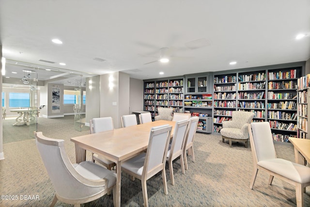 dining room with light colored carpet and ceiling fan