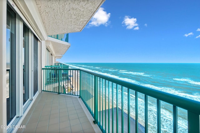 balcony with a beach view and a water view