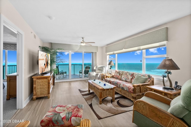 living room featuring light hardwood / wood-style floors and ceiling fan