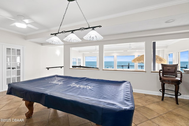 recreation room with tile patterned floors, ornamental molding, and a water view