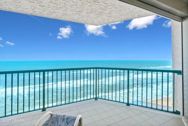 balcony with a view of the beach and a water view