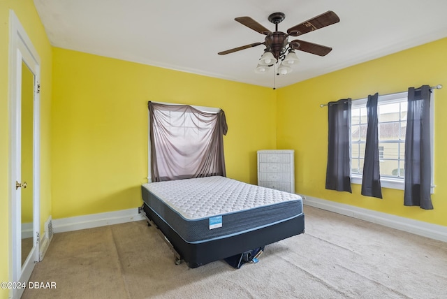 carpeted bedroom with baseboards and ceiling fan