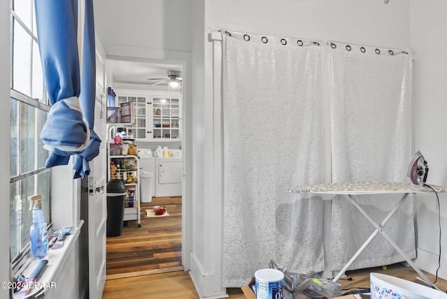 bathroom featuring washer and dryer, wood finished floors, and a ceiling fan