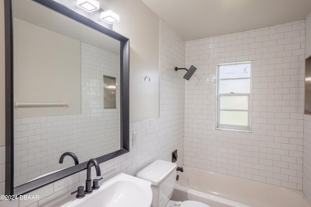 bathroom featuring toilet, tile walls, tiled shower / bath, and tasteful backsplash