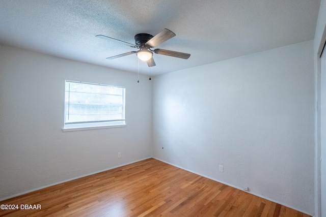 unfurnished room with wood-type flooring, a textured ceiling, and ceiling fan