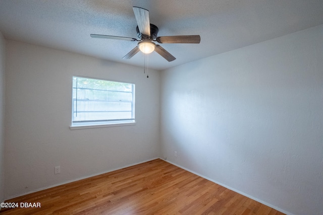 unfurnished room with light wood-type flooring and ceiling fan