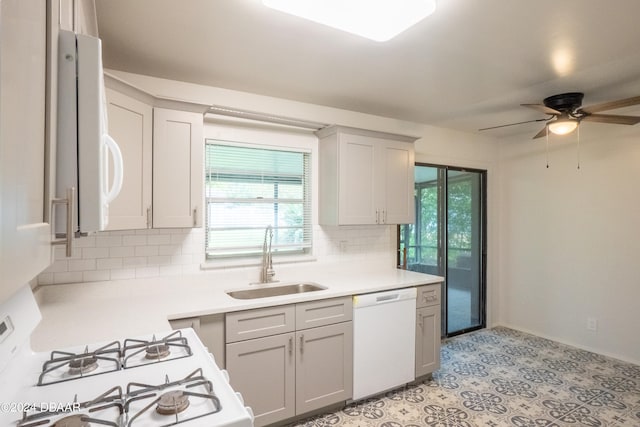 kitchen with tasteful backsplash, sink, a healthy amount of sunlight, and white appliances