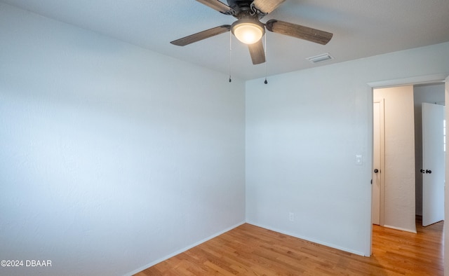 spare room featuring ceiling fan and light hardwood / wood-style flooring