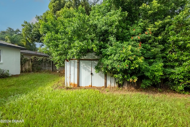 view of outbuilding featuring a yard