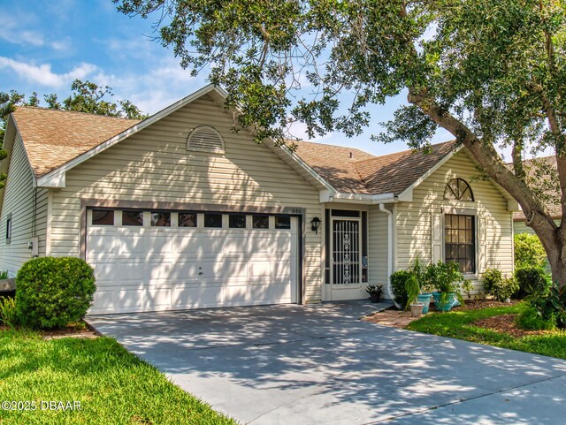 686 Middlebury Loop, New Smyrna Beach, FL 32168 - ranch-style home with an attached garage, concrete driveway, and roof with shingles