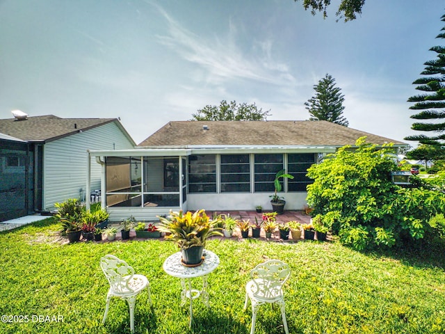 686 Middlebury Loop, New Smyrna Beach, FL 32168 - back of house featuring a sunroom, a lawn, and roof with shingles