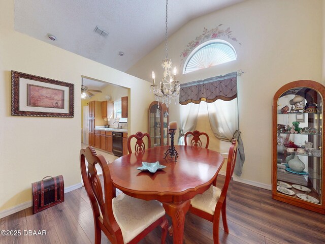 686 Middlebury Loop, New Smyrna Beach, FL 32168 - dining room featuring lofted ceiling, a chandelier, wood finished floors, ceiling fan, and baseboards
