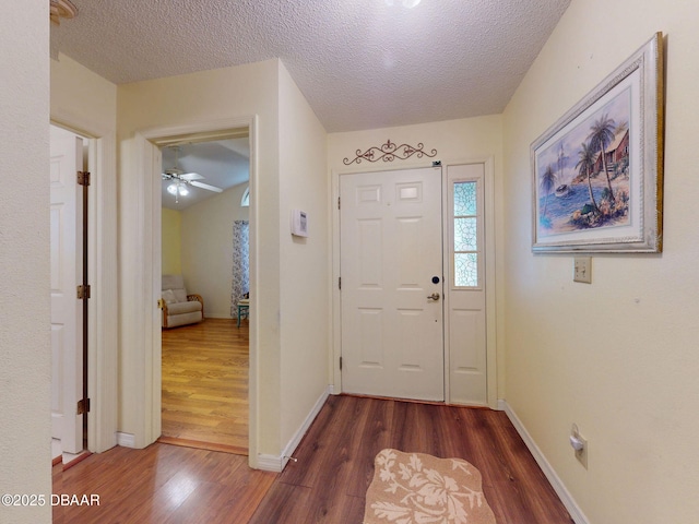 686 Middlebury Loop, New Smyrna Beach, FL 32168 - entryway featuring dark wood-style floors, a textured ceiling, baseboards, and a ceiling fan