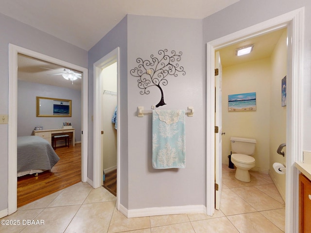 686 Middlebury Loop, New Smyrna Beach, FL 32168 - bathroom with tile patterned floors, toilet, vanity, a ceiling fan, and a walk in closet