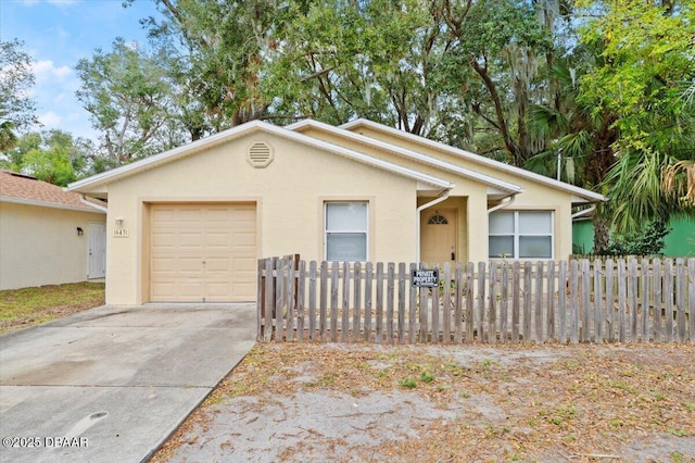 ranch-style home with a garage, concrete driveway, fence, and stucco siding