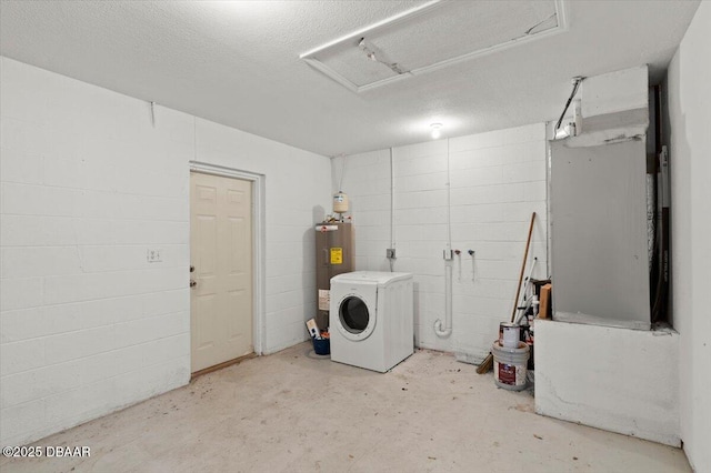 laundry room with concrete block wall, washer / dryer, attic access, a textured ceiling, and water heater