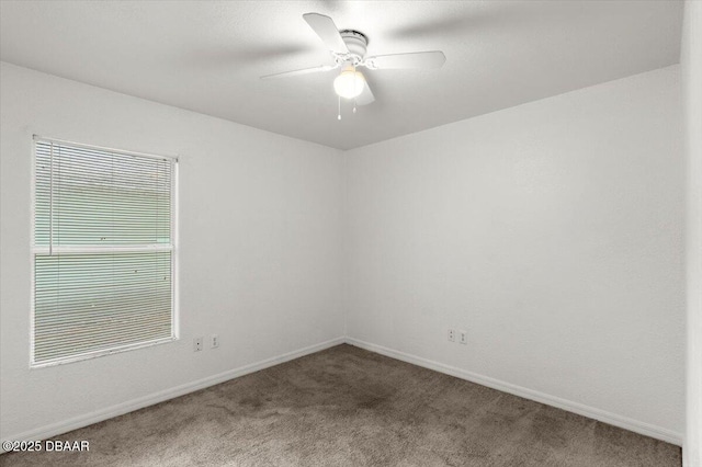 spare room featuring ceiling fan, carpet flooring, and baseboards