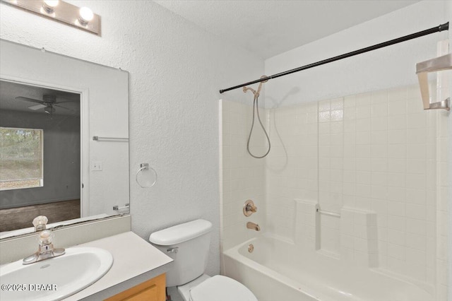 full bathroom with  shower combination, a textured wall, vanity, and toilet