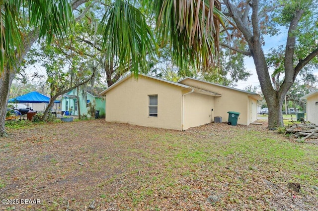 rear view of house with stucco siding