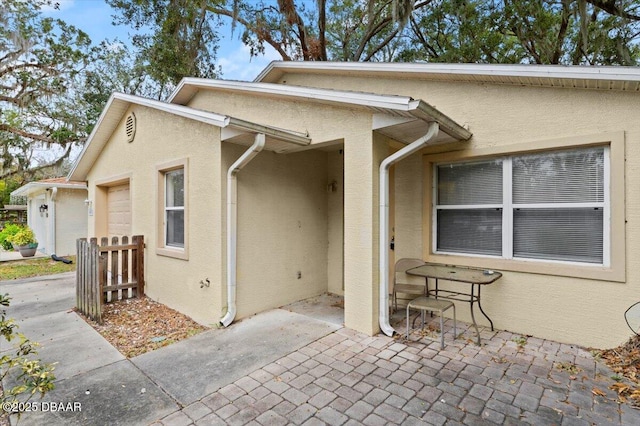 exterior space with a patio area and stucco siding