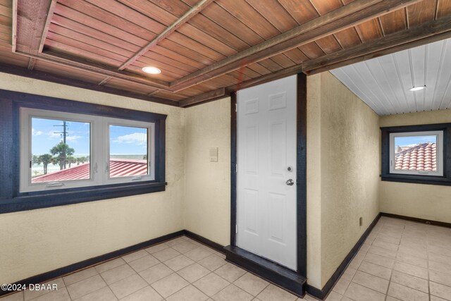 interior space with wooden ceiling and light tile patterned flooring